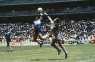 Argentina's Diego Maradona scores 1st goal with his 'Hand of God', past England goalkeeper Peter Shilton.